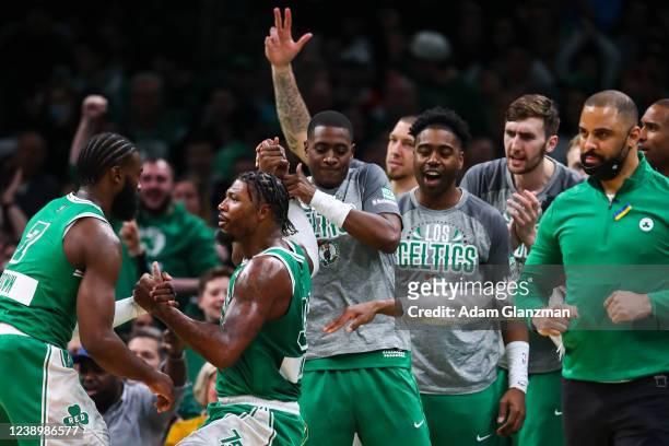Marcus Smart of the Boston Celtics reacts with teammate skater hitting a three-point shot during a game against the Brooklyn Nets at TD Garden on...