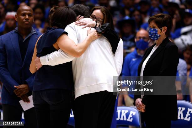 Head coach Mike Krzyzewski of the Duke Blue Devils hugs his daughters Lindy Frasher, Jamie Spatola and Debbie Savarino as his wife Mickie looks on...