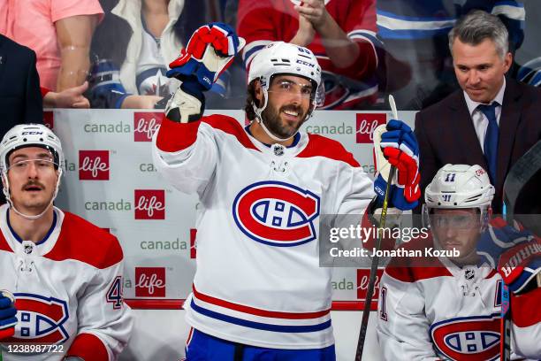 Mathieu Perreault of the Montreal Canadiens acknowledges the fans following a video montage during a first period stoppage in play against the...