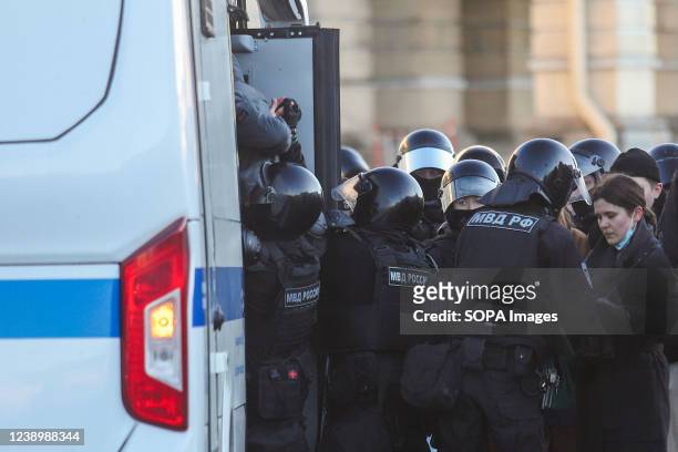 Police Officers detain protestors during a demonstration against the Russian military operation in Ukraine.