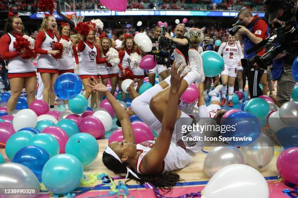 State Wolfpack forward Kayla Jones dives into the balloons after winning the ACC Tournament championship game between the North Carolina State...
