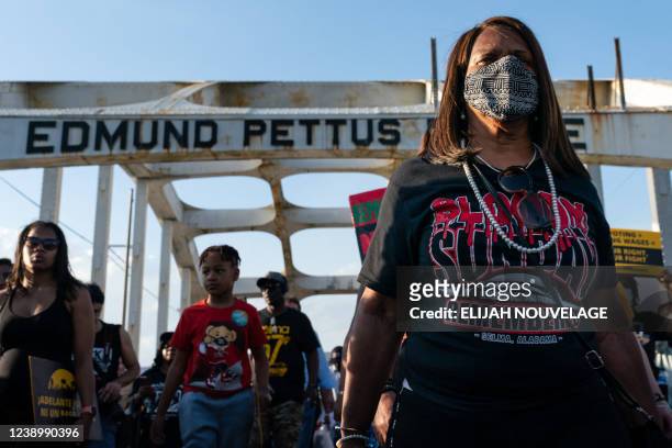 Woman wears a 'Bloody Sunday Remembered' shirt as she marches across the Edmund Pettus Bridge in commemoration of the 57th anniversary of 'Bloody...