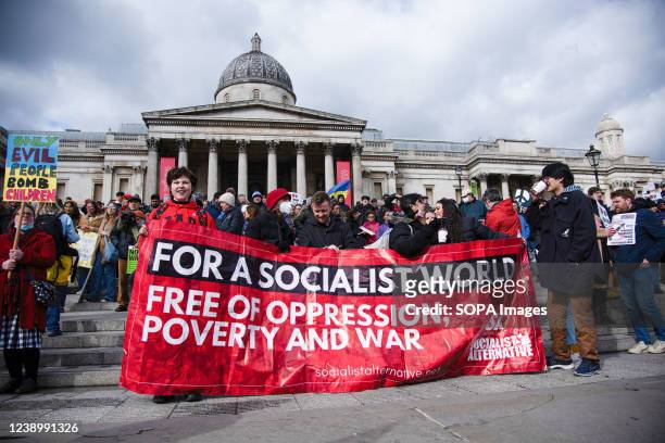 Socialist activists hold a large banner at Trafalgar Square to protest against Russian attacks on Ukraine in London.