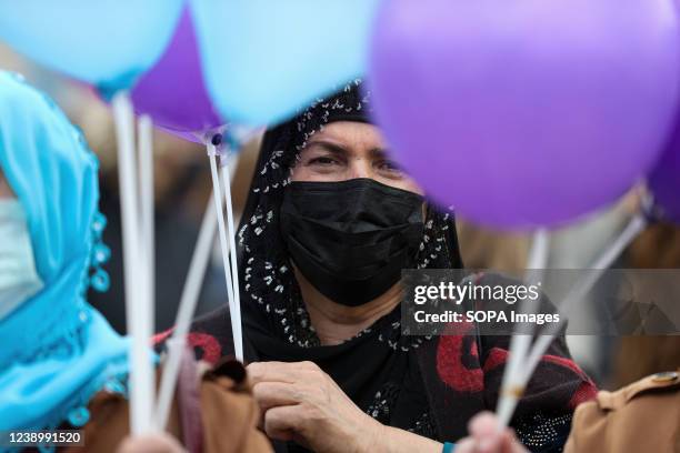 Protester carries a balloon during a rally prior to women's day. Female protesters took to the streets of Ankara on the occasion of International...