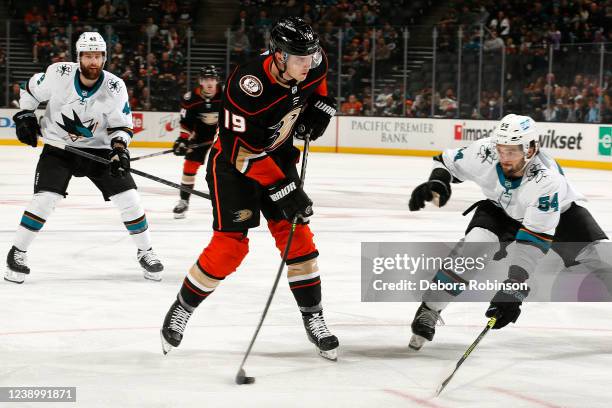 Troy Terry of the Anaheim Ducks skates with the puck against Scott Reedy of the San Jose Sharks during the game at Honda Center on March 6, 2022 in...