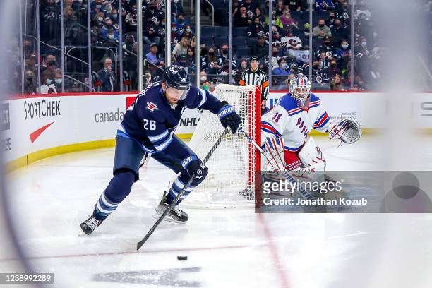 Blake Wheeler of the Winnipeg Jets plays the puck as goaltender Igor Shesterkin of the New York Rangers guards the net during second period action at...