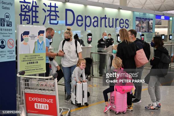 Expat familes depart Hong Kong's Chek Lap Kok international airport on March 6, 2022 as travel restrictions hit hard on Hong Kong's white collar...