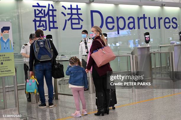 Expat familes depart Hong Kong's Chek Lap Kok international airport on March 6, 2022 as travel restrictions hit hard on Hong Kong's white collar...