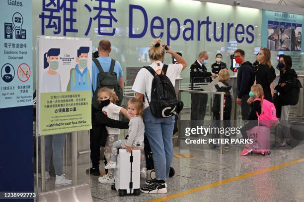 Expat familes depart Hong Kong's Chek Lap Kok international airport on March 6, 2022 as travel restrictions hit hard on Hong Kong's white collar...