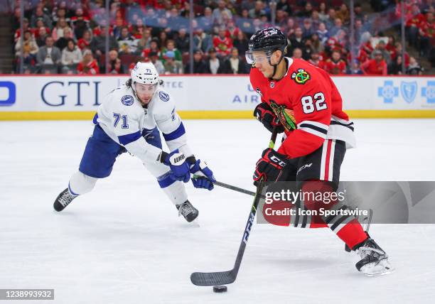 Chicago Blackhawks defenseman Caleb Jones and Tampa Bay Lightning center Anthony Cirelli in action during a game between the Tampa Bay Lightning and...