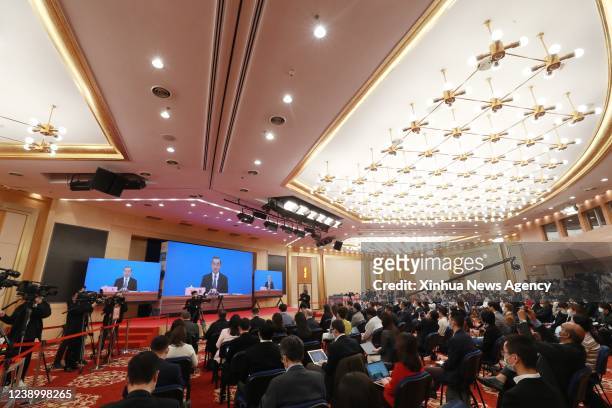 Journalists attend a press conference held by Chinese State Councilor and Foreign Minister Wang Yi via video link in Beijing, capital of China, March...