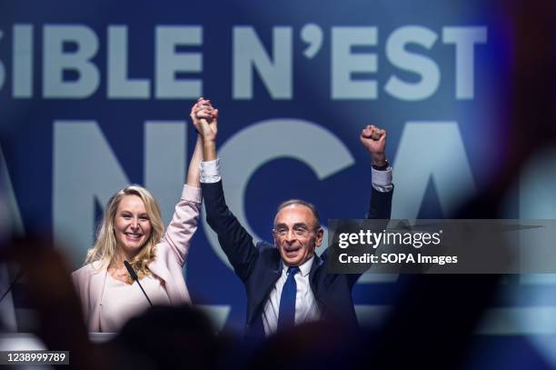 Eric Zemmour and Marion Marechal - Le Pen are holding hands to greet the audience. Eric Zemmour, the extreme right-wing candidate of the Reconquete...