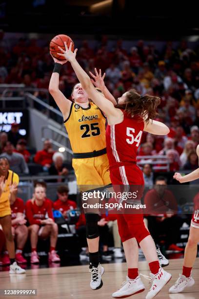 Iowa Hawkeyes forward Monika Czinano goes to the hoop against Indiana Hoosiers forward Mackenzie Holmes during the NCAA basketball Women's Big Ten...