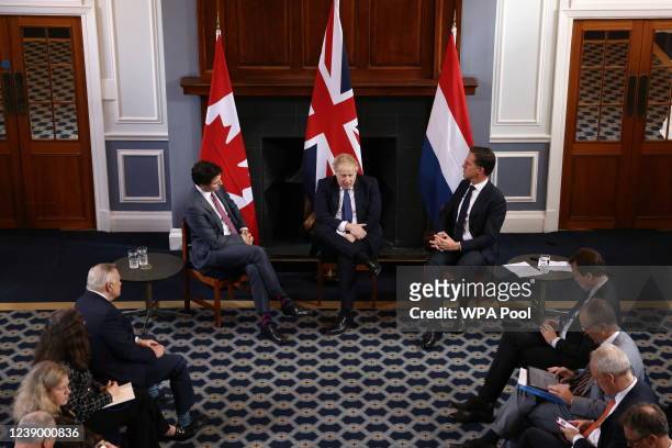British Prime Minister Boris Johnson speaks as he meets Canadian Prime Minister Justin Trudeau and Dutch Prime Minister Mark Rutte at RAF Northolt on...