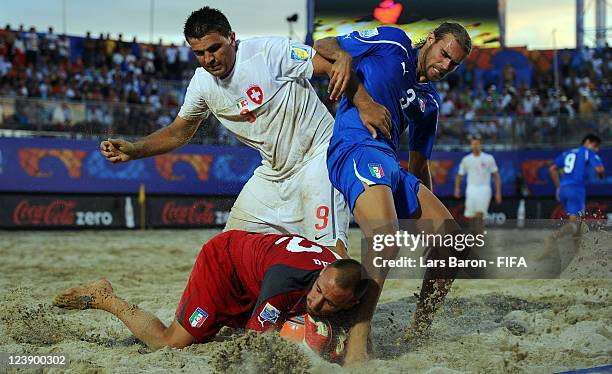 Dejan Stankovic of Switzerland is challenged by goalkeeper Stefano Spada and ario Ramacciotti of Italy during the FIFA Beach Soccer World Cup Group A...