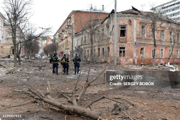 Ukrainian police officers patrol a street following a shelling in Ukraine's second-biggest city of Kharkiv on March 7, 2022. - On the 12th day of...