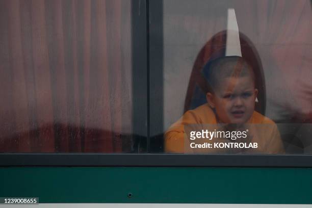 Ukrainian refugee child aboard a bus that will take him to a reception center in Poland after crossing the border crossing from Ukraine to Poland in...