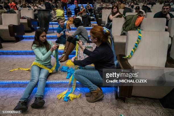 Czech volunteers play with the children of Ukrainian refugees in the regional assistance centre at the Prague Congress Centre on March 7 in Prague,...