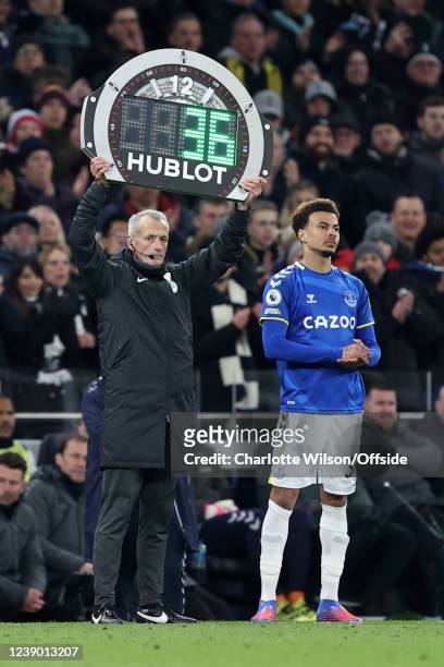 Fourth Official Martin Atkinson holds up his board as Dele Alli of Everton prepares to come on as a substitute against his old club during the...