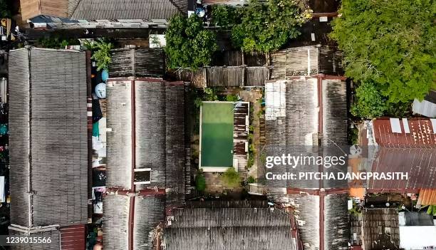 This aerial screenshot from an AFPTV video taken on February 10, 2022 shows a swimming pool in the courtyard of the So Heng Tai mansion in the Talad...