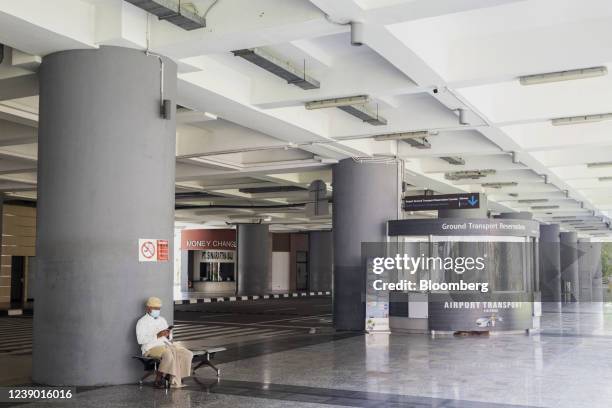 An airport worker waits for the arrival of the passengers at Ngurah Rai International Airport in Bali, Indonesia, on Monday, March 7, 2022. Indonesia...