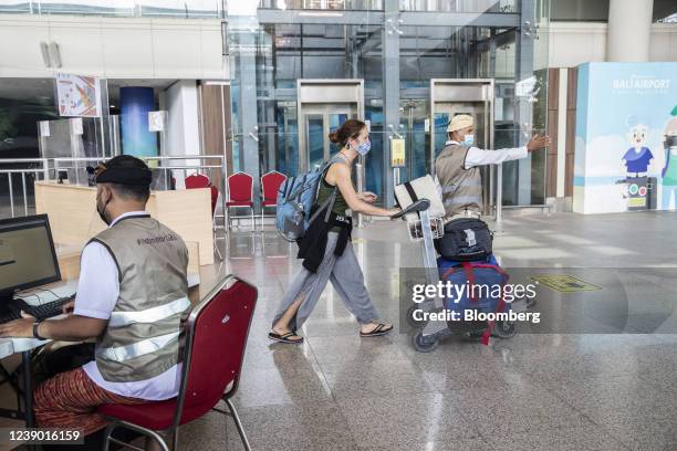 Traveler, center, arrives at Ngurah Rai International Airport in Bali, Indonesia, on Monday, March 7, 2022. Indonesia started to allow...