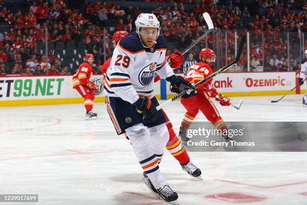 Leon Draisaitl of the Edmonton Oilers battles against the Calgary Flames at Scotiabank Saddledome on March 7, 2022 in Calgary, Alberta, Canada.