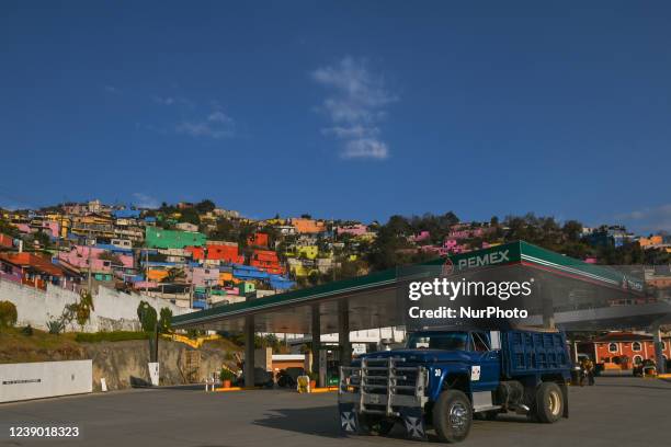 Pemex gas station with the colorful houses in Barrio San Diego neighborhood of San Cristobal de las Cacas, in the background. On Monday, March 7 in...