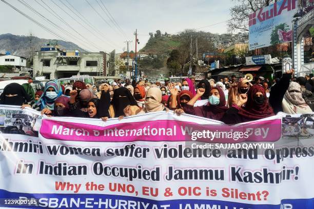 Kashmiri women shout slogans as they march to mark International Women's Day in Muzaffarabad, the capital of Pakistani-administered Kashmir, on March...