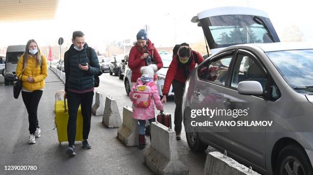 Photograph taken on March 7, 2022 shows Russians as they take a taxi at the airport upon their arrival in Tbilisi. - Anti-Russian sentiment is...