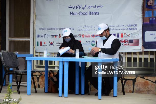 United Nations High Commissioner for Refugees workers prepare to distribute non-food items to women at UNHCR office in Kandahar on March 8, 2022.