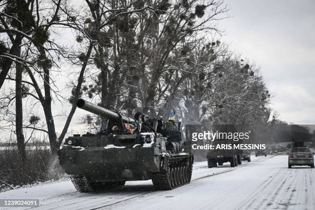 An Ukrainian tank rolls along a main road on March 8, 2022. - Kyiv and its allies rejected a previous proposal to evacuate Ukrainians to Russia as a...