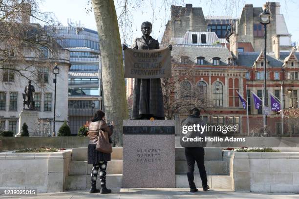 People take photos of the Millicent Fawcett statue in Parliament Square on International Women's Day, March 8, 2022 in London, England. Unveiled in...