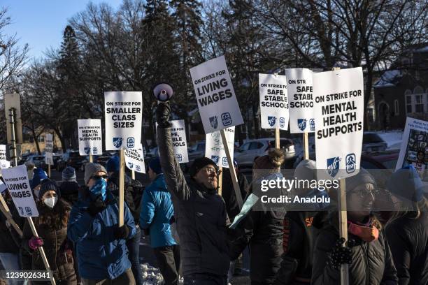 Minneapolis school teachers hold placards during the strike in front of the Justice Page Middle school in Minneapolis, Minnesota, United States on...