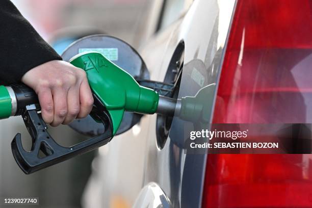 Woman fills up her car with diesel at a petrol station in Mulhouse, eastern France, on March 8, 2022. The price of diesel soared by more than 14...
