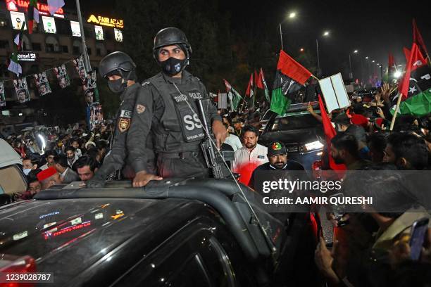 Security personnel escort a truck carrying Chairman of PPP Bilawal Bhutto Zardari, leading an anti-government rally in Islamabad on March 8, 2022 as...