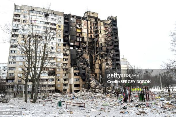 This picture shows an apartment building damaged after shelling the day before in Ukraine's second-biggest city of Kharkiv on March 8, 2022. - The...