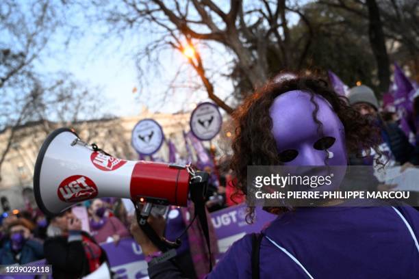 Demonstrator uses a megaphone to shout slogans during a demonstration marking International Women's Day in Madrid on March 8, 2022. - Thousands of...