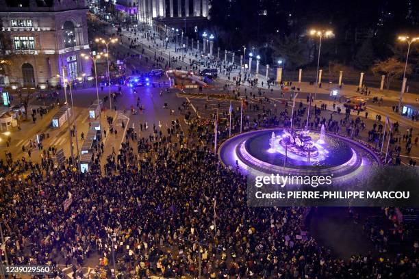 Demonstrators march through Cibeles square during a demonstration marking International Women's Day in Madrid on March 8, 2022. - Thousands of...