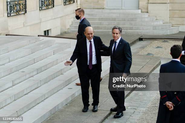 France's European and Foreign Affairs Minister Jean-Yves Le Drian welcomes US Secretary of State Antony Blinken at the Elysee palace in Paris before...