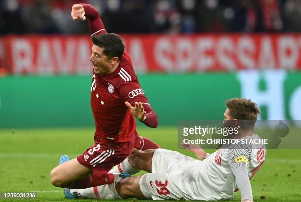 Bayern Munich's Polish forward Robert Lewandowski is brought down by Salzburg's Austrian defender Maximilian Woeber giving away a penalty for the...