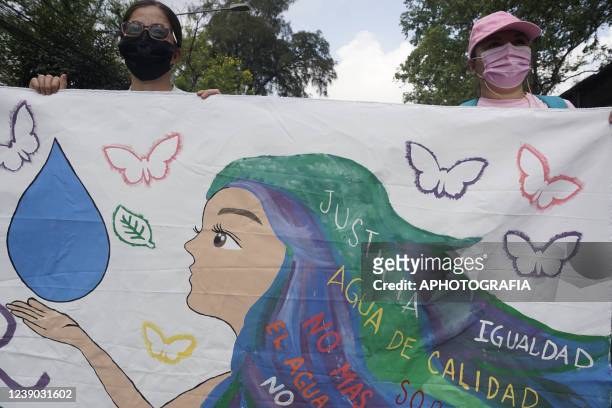 Women hold a large banner during a demonstration as part of the International Women's Day on March 8, 2022 in San Salvador, El Salvador.