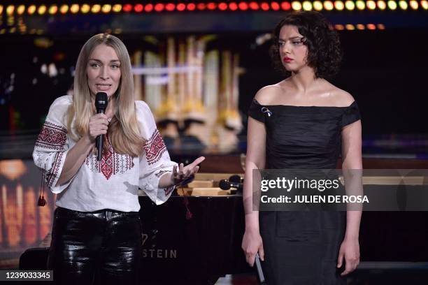 Leader of the feminist activist group Femen Inna Shevchenko speaks, flanked by French-Georgian concert pianist Khatia Buniatishvili in Paris on March...