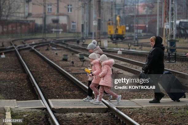 Some children with their mother Ukrainian refugees at the Przemysl railway station in Poland go towards the platforms to catch a train to reach a...