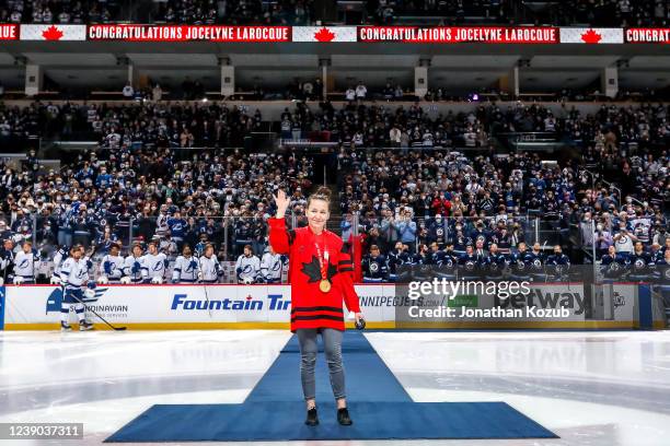 Olympic Gold medalist Jocelyne Larocque of the Canadian Women's Hockey team waves to the crowd prior to the ceremonial puck drop between the Winnipeg...