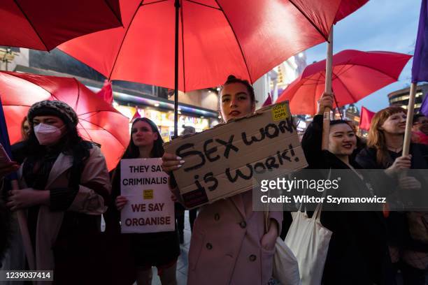 Sex workers and their supporters hold placards and red umbrellas as they protest in Leicester Square during 'We Want to Live' demonstration held on...