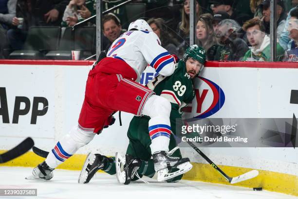 Patrik Nemeth of the New York Rangers and Frederick Gaudreau of the Minnesota Wild compete for the puck in the first period at Xcel Energy Center on...