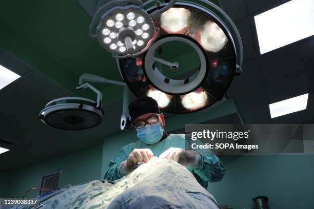 Palestinian doctor in the Gaza Strip performs a plastic surgery on a patient's nose. Cosmetic surgery clinics have become popular all over the strip.