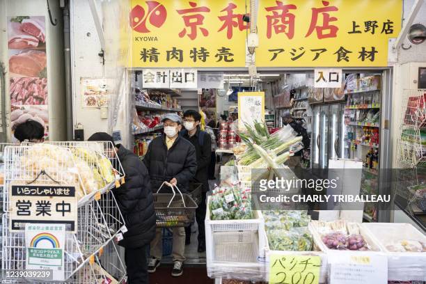 People shop in Tokyo's Ueno area at morning on February 9, 2022.
