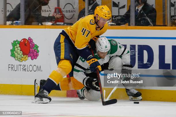 Michael McCarron of the Nashville Predators drives Joe Pavelski of the Dallas Stars to the ice during the third period at Bridgestone Arena on March...